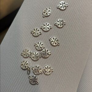 Tory Burch charms. Silver. New. 14 charms.